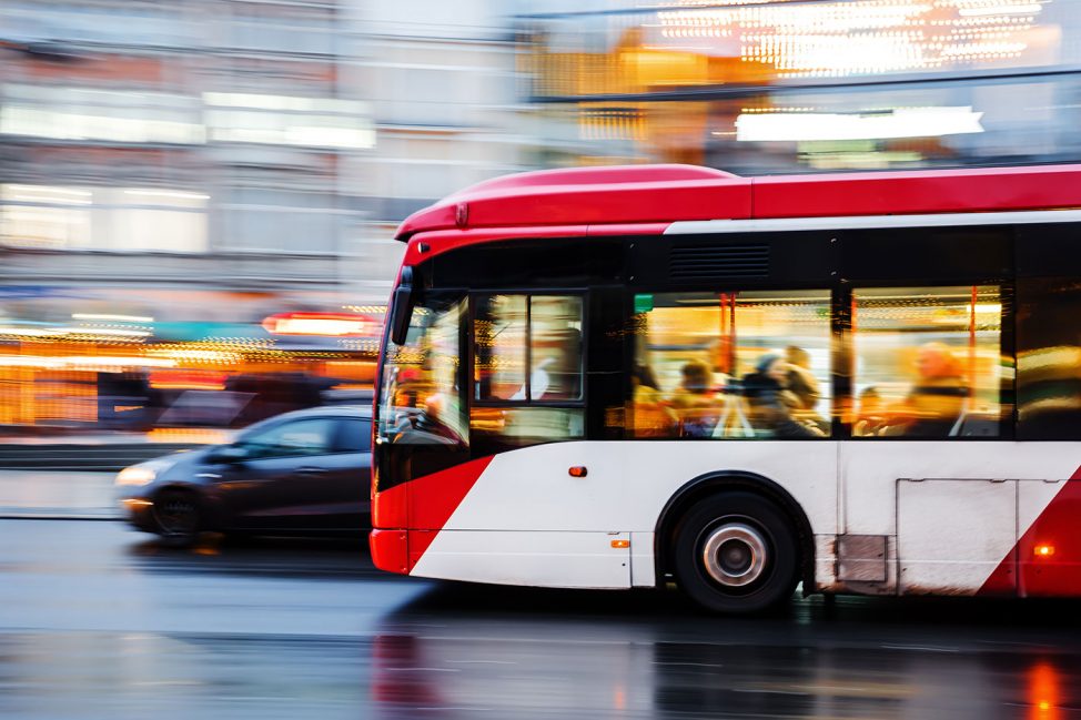 Picture-of-a-public-transportation-bus-in-city-traffic-in-motion-with-a-blurred-background